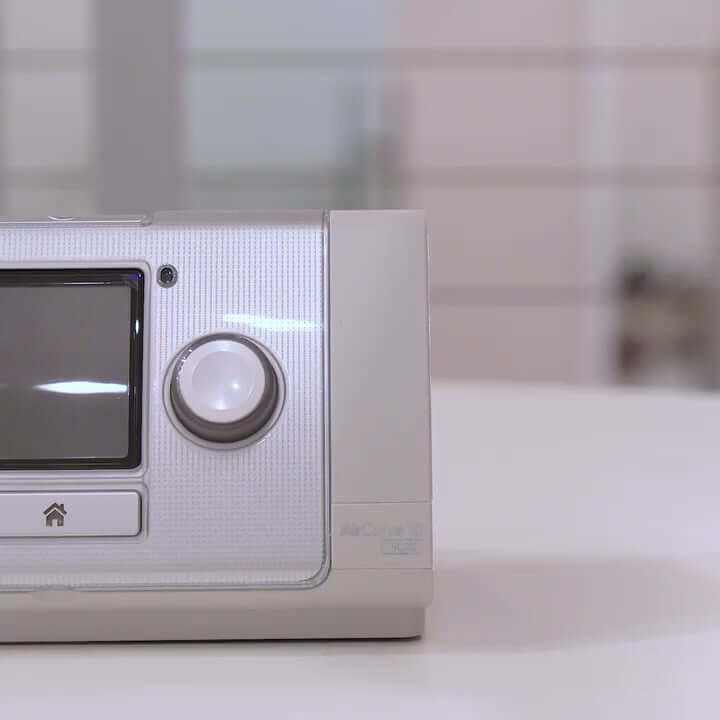 ResMed AirCurve 10 ST BiLevel Machine for sleep apnea and breathing disorders placed on a table.