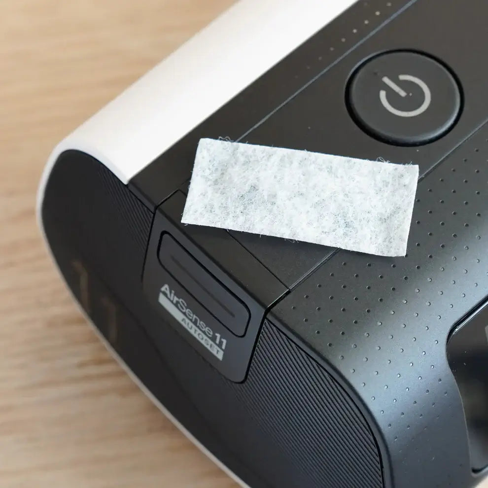 AirSense 11 CPAP machine with replacement filter pad, ensuring clean air and optimal performance; easy-to-install filter pack.