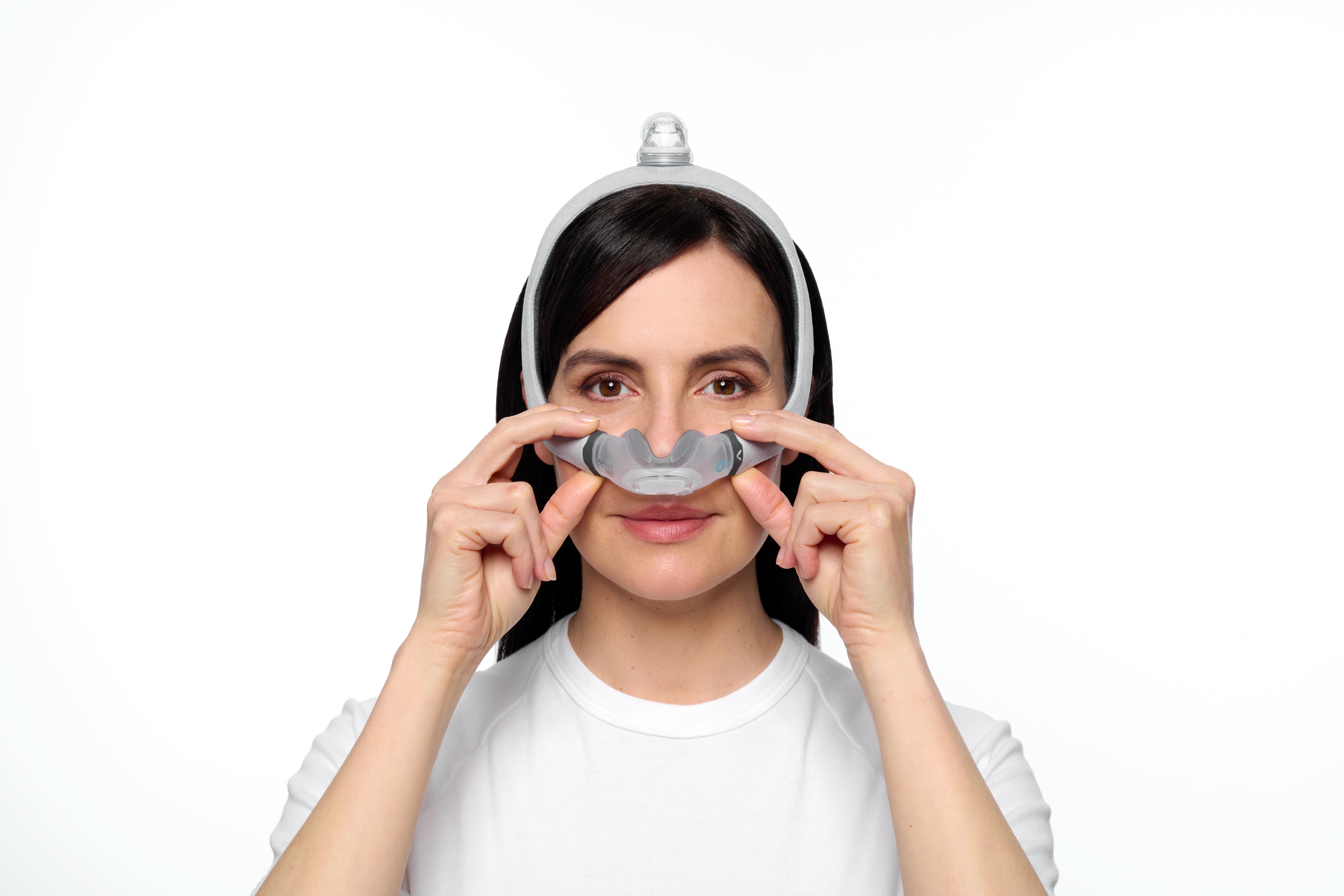 ResMed AirTouch N30i nasal cradle mask being fitted — official ResMed fitting photograph