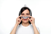 ResMed AirTouch N30i nasal cradle mask being fitted — official ResMed fitting photograph