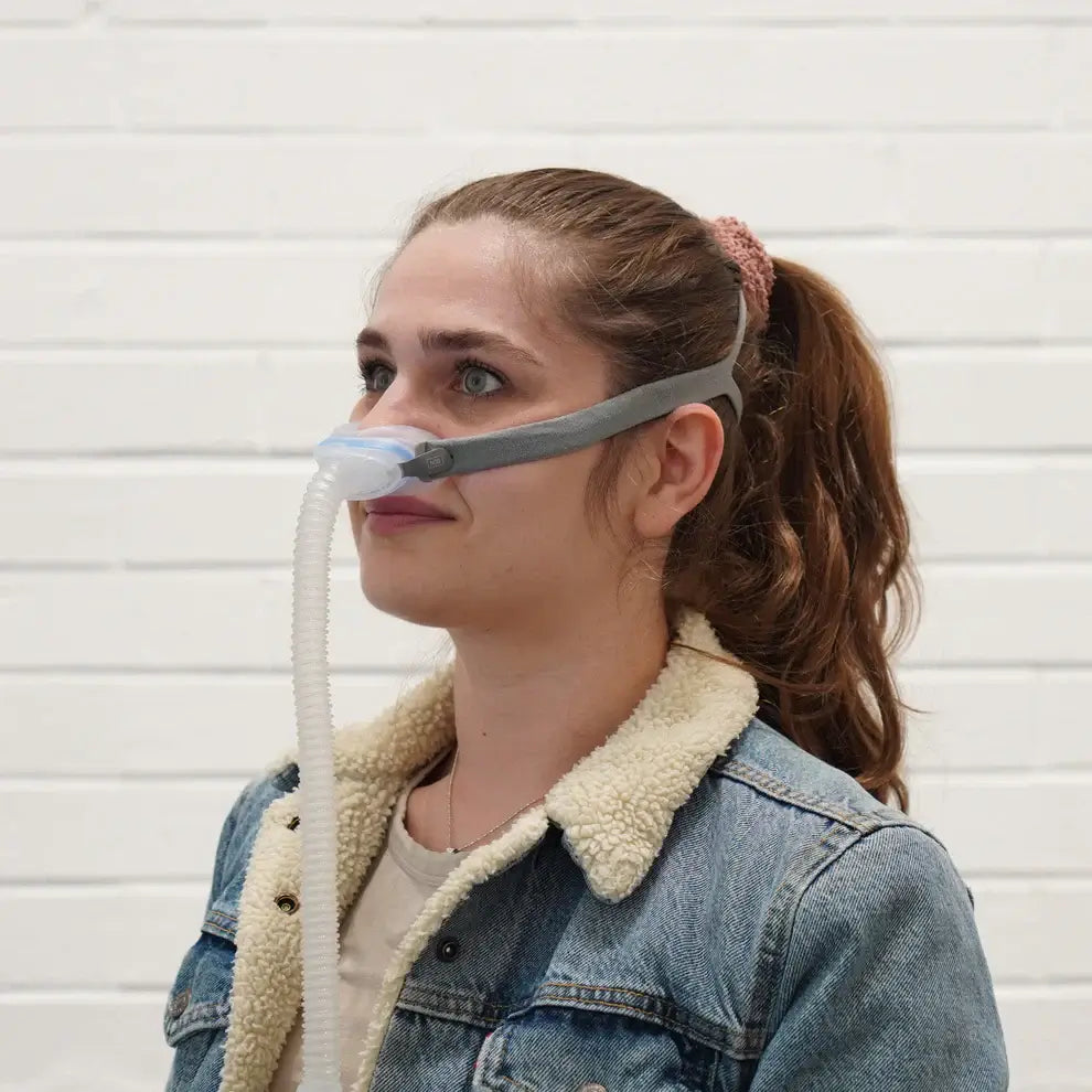 Woman wearing ResMed AirFit N30 Nasal Cushion Mask with QuickFit elastic headgear, showcasing its minimal contact and comfort features.
